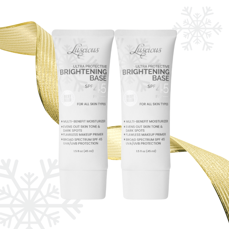 Two tubes of Luscious Cosmetics Ultra Protective Brightening Base SPF 45 on a white background with a gold ribbon.