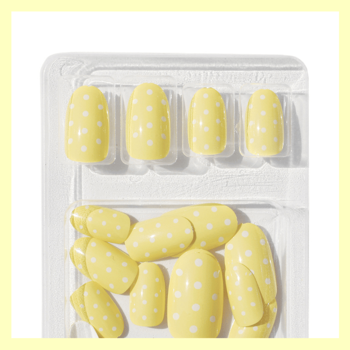 Luscious Cosmetics Butter Yellow short press-on nails displayed in packaging.