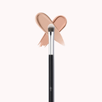 Luscious Cosmetics makeup brush with a pink bow detail and beige color swatch on a white background.
