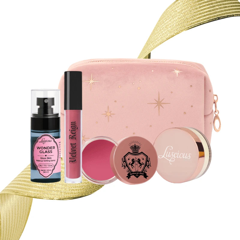 Luscious Cosmetics Deluxe Makeup Kit Pink featuring a pink makeup pouch, lip products, and setting spray on a white background.