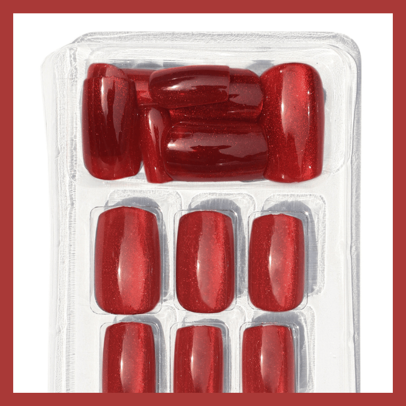 Luscious Cosmetics Dutch Roses medium press-on nails in red, displayed in clear plastic packaging on a white background.