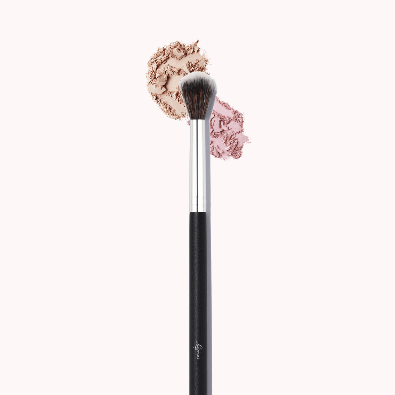 Luscious Cosmetics eyeshadow blender brush with pink makeup powder on a white background.