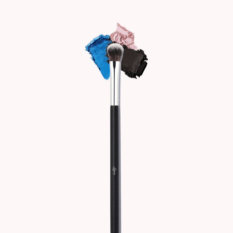 Luscious Cosmetics eyeshadow packer brush with colorful bristle tips on a white background.