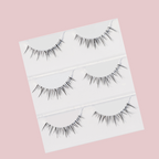 Luscious Cosmetics Fairy Luxe 3D false eyelashes displayed in clear packaging on a soft pink background.
