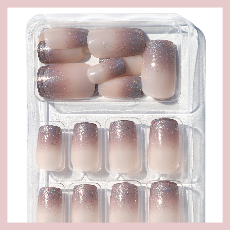 Luscious Cosmetics transparent press-on nails with glittery silver tips for a clean, glossy look.
