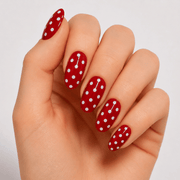 Hand wearing Luscious Cosmetics Ladybug Summer short press-on design.