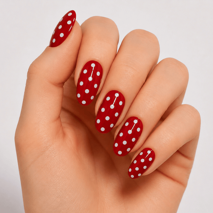 Hand wearing Luscious Cosmetics Ladybug Summer short press-on design.