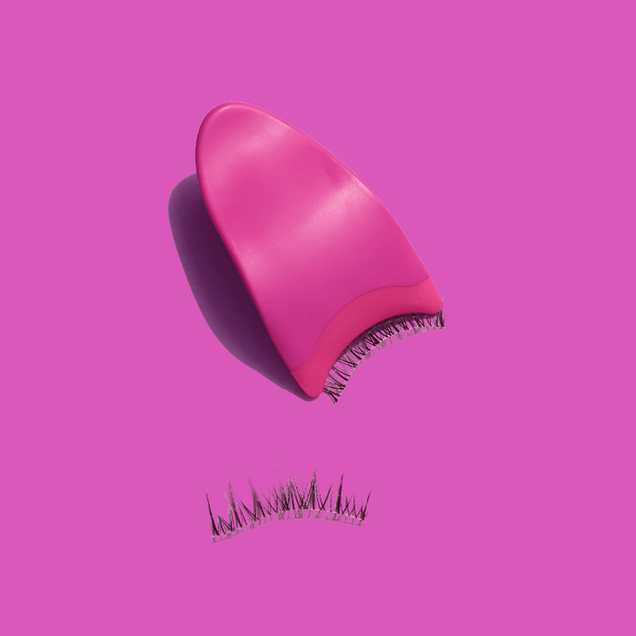 Luscious Cosmetics Lash Genius applicator with pink bristles on a pink background.
