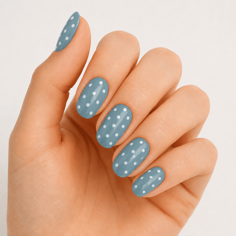 Hand wearing Luscious Cosmetics Teal Tea Party short press-on design.
