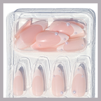 A clear plastic package containing multiple medium-length press-on nails by Luscious Cosmetics with a pearl design.