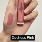 Luscious Cosmetics Velvet Reign Liquid Lipstick in a pink shade with the cap off, showing a lipstick swatch beside the tube.