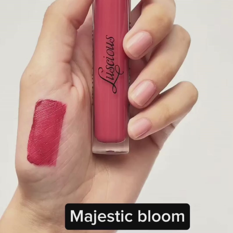 Pink lip gloss with applicator from Luscious Cosmetics Velvet Reign collection displayed on a white background.