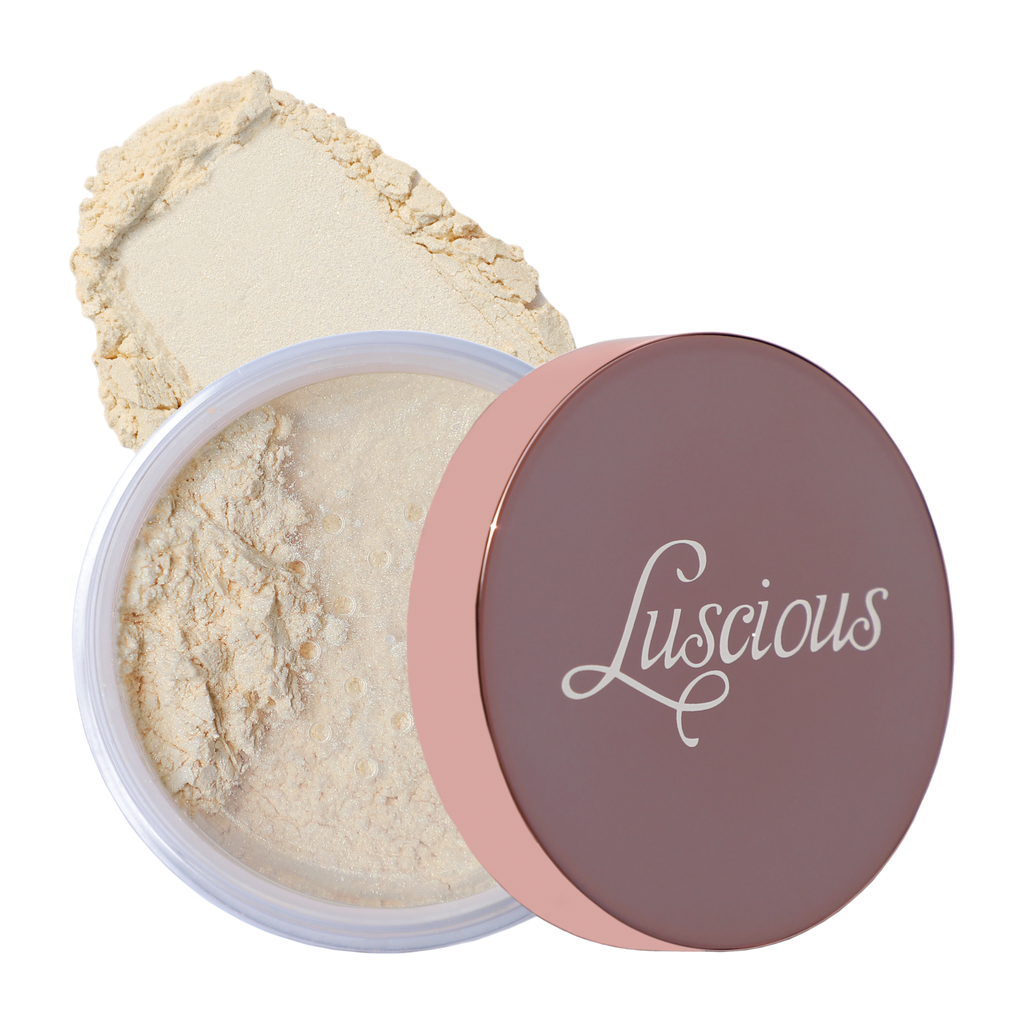 Jar of Luscious Cosmetics highlighter powder with the lid off, revealing a shimmery light pink luminizer.